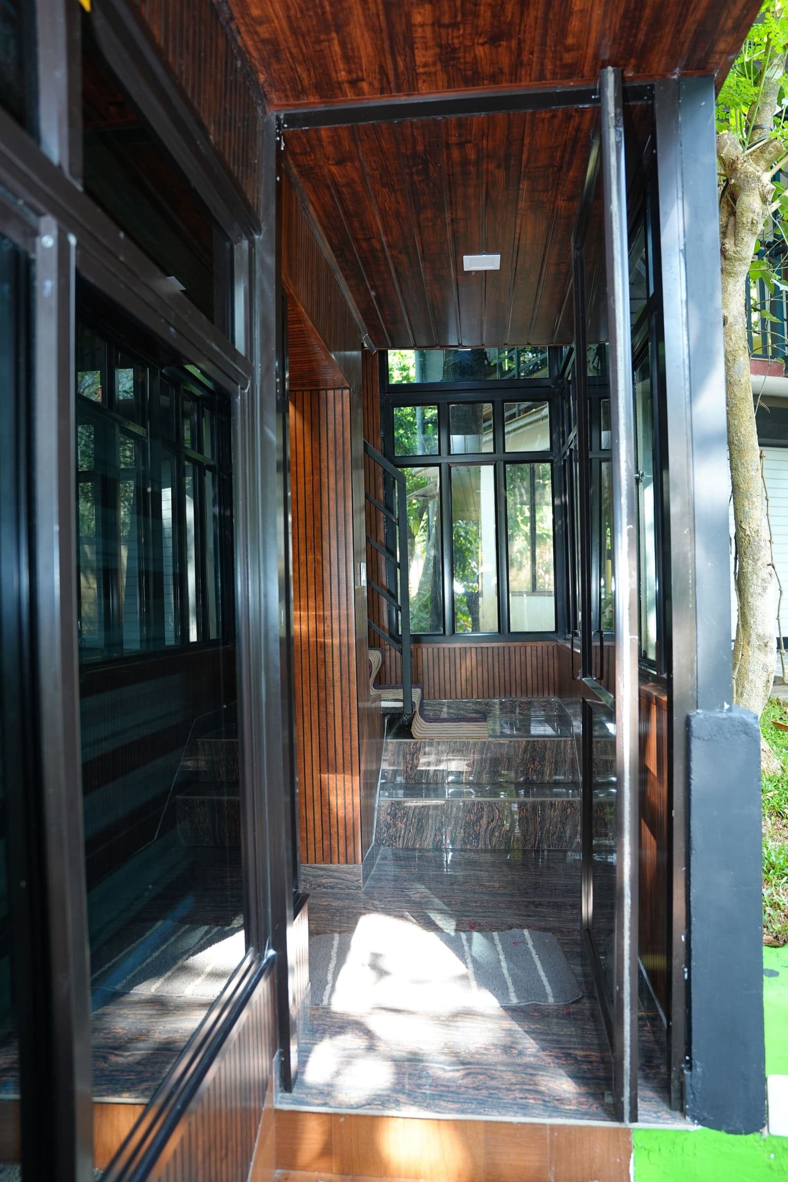 Glass Corridor Garden View — Kaivalyam Homestay, Padichira, Wayanad
